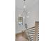 Bright staircase featuring modern lighting, hardwood stairs, and window overlooking green space at 215 Fell Pt, Daniel Island, SC 29492