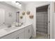 Bright bathroom features a double sink vanity and a shower with a colorful curtain at 219 Seaworthy St, Summerville, SC 29486