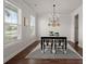 Bright dining room with natural light, hardwood floors, decorative light fixture, and white trim at 219 Seaworthy St, Summerville, SC 29486