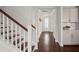 Bright entryway featuring hardwood floors, stairs with wood handrail, and decorative lighting at 219 Seaworthy St, Summerville, SC 29486