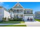 Charming two-story home with a welcoming porch, landscaped yard, and attached two-car garage with golf cart at 219 Seaworthy St, Summerville, SC 29486