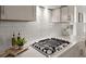 Close-up of kitchen featuring gas range, tile backsplash, and quartz countertops at 219 Seaworthy St, Summerville, SC 29486