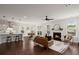 Open concept living room with hardwood floors, a fireplace, and seamless access to the kitchen and dining area at 219 Seaworthy St, Summerville, SC 29486