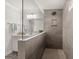 Modern bathroom shower with sleek gray tile, glass partition, and a wall niche at 219 Seaworthy St, Summerville, SC 29486
