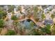 A peaceful aerial view of a pond surrounded by lush trees and the rooftops of surrounding homes at 2217 Beckenham Dr, Mount Pleasant, SC 29466