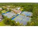 Aerial view of a community's tennis courts, pool and clubhouse surrounded by verdant trees under a partly cloudy sky at 2217 Beckenham Dr, Mount Pleasant, SC 29466
