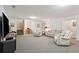 Spacious carpeted basement living area featuring comfortable seating and a built-in desk space at 2217 Beckenham Dr, Mount Pleasant, SC 29466