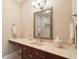 Bathroom vanity with marble countertop, dark wood cabinets, and decorative mirror at 2217 Beckenham Dr, Mount Pleasant, SC 29466