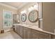 A stylish bathroom with a double sink vanity, decorative mirrors, and ample storage at 2217 Beckenham Dr, Mount Pleasant, SC 29466
