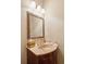 Elegant powder room with a marble countertop and decorative mirror at 2217 Beckenham Dr, Mount Pleasant, SC 29466
