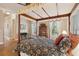Bedroom with hardwood floors, large windows, canopy bed, and stylish decor at 2217 Beckenham Dr, Mount Pleasant, SC 29466