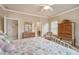 A bright bedroom features a four-poster bed, neutral walls, wood furniture, and lots of sunlight at 2217 Beckenham Dr, Mount Pleasant, SC 29466