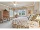 A cozy bedroom featuring a four-poster bed, wood furniture, and soft, natural light at 2217 Beckenham Dr, Mount Pleasant, SC 29466