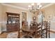 Elegant dining room features a wooden table with seating for six and a classic china cabinet at 2217 Beckenham Dr, Mount Pleasant, SC 29466