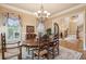 This dining room features a chandelier, wood table with six chairs, and decorative window treatments at 2217 Beckenham Dr, Mount Pleasant, SC 29466