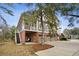 Elevated home featuring a screened porch, brick foundation, and attached garage at 2217 Beckenham Dr, Mount Pleasant, SC 29466