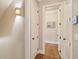 Hallway with hardwood floors, neutral paint, decorative lighting, and doorway to bedroom at 2217 Beckenham Dr, Mount Pleasant, SC 29466