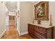 Spacious hallway features hardwood floors, decorative chest, artwork and staircase at 2217 Beckenham Dr, Mount Pleasant, SC 29466