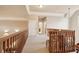 An upstairs hallway with wood railing and multiple doorways to other rooms at 2217 Beckenham Dr, Mount Pleasant, SC 29466