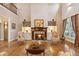 Spacious living room features a cozy fireplace with built-in shelving and gleaming hardwood floors at 2217 Beckenham Dr, Mount Pleasant, SC 29466
