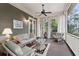 Relaxing screened porch with cozy seating and a ceiling fan for added comfort at 2217 Beckenham Dr, Mount Pleasant, SC 29466
