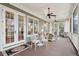 Inviting screened porch with comfortable seating and a dining area at 2217 Beckenham Dr, Mount Pleasant, SC 29466
