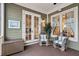 Relaxing screened porch area with wicker chairs, olive green siding, and double doors at 2217 Beckenham Dr, Mount Pleasant, SC 29466