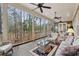 Inviting screened porch with ceiling fans, wicker furniture, and scenic wooded views at 2217 Beckenham Dr, Mount Pleasant, SC 29466
