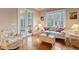 Cozy sun room with large windows, natural light, hardwood floors and wicker furniture at 2217 Beckenham Dr, Mount Pleasant, SC 29466