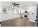 Open-concept living space with wood-look floors connecting the living area to the modern, all-white kitchen at 224 Legare Rd, Saint George, SC 29477