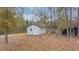 Picture of an unfinished outbuilding with double doors and a yard full of leaves at 242 Jacob Piland Rd, Moncks Corner, SC 29461