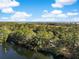 Aerial view of a house with lake frontage and beautiful mature trees, and distant ocean view at 2824 Old Drake Dr, Seabrook Island, SC 29455