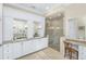 Bright bathroom with double vanity, stone countertops, step-in shower with glass enclosure, and a makeup vanity at 2824 Old Drake Dr, Seabrook Island, SC 29455