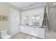 Elegant bathroom with double vanity, granite countertops, white cabinets, and a step-in shower with a glass enclosure at 2824 Old Drake Dr, Seabrook Island, SC 29455