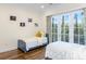 Bright bedroom with twin beds, neutral walls, and french doors to the outside at 2824 Old Drake Dr, Seabrook Island, SC 29455