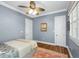 Cozy bedroom features a ceiling fan, wood floors, and ample natural light at 2824 Old Drake Dr, Seabrook Island, SC 29455
