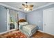 Comfortable bedroom with ceiling fan, wood floors, and ensuite bathroom access at 2824 Old Drake Dr, Seabrook Island, SC 29455
