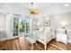Airy bedroom with hardwood floors, French doors, and a stylish ceiling fan at 2824 Old Drake Dr, Seabrook Island, SC 29455