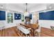 Dining room featuring blue accent wall, hardwood floors and view of a connected room at 2824 Old Drake Dr, Seabrook Island, SC 29455