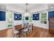 Dining room featuring blue accent wall, decorative plates, and hardwood floors at 2824 Old Drake Dr, Seabrook Island, SC 29455