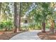A quaint home with a tree-lined walkway leading to the front porch at 2824 Old Drake Dr, Seabrook Island, SC 29455
