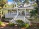 Charming two-story home with white trim, a spacious porch, stairs and manicured landscaping at 2824 Old Drake Dr, Seabrook Island, SC 29455