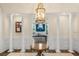 Charming foyer with wainscoting, columns, and chandelier, leading to dining area at 2824 Old Drake Dr, Seabrook Island, SC 29455
