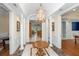 Elegant foyer with marble floors, wainscoting, columns, and a decorative light fixture at 2824 Old Drake Dr, Seabrook Island, SC 29455