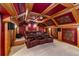 Home theater with tiered seating, patterned walls, and coffered ceilings at 2824 Old Drake Dr, Seabrook Island, SC 29455