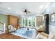 Open-concept living area with built-in cabinets, hardwood floors, French doors, and comfortable seating with a ceiling fan at 2824 Old Drake Dr, Seabrook Island, SC 29455