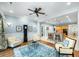 Spacious living room with built-in cabinets, hardwood floors, a ceiling fan, and comfortable seating near the kitchen at 2824 Old Drake Dr, Seabrook Island, SC 29455