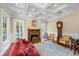 Elegant living room featuring coffered ceilings, fireplace, and access to outdoor space at 2824 Old Drake Dr, Seabrook Island, SC 29455