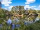 Scenic waterfront view of a property on a pond amidst lush trees at 2824 Old Drake Dr, Seabrook Island, SC 29455