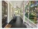 Inviting front porch with rocking chairs and a dark-stained wood floor at 2824 Old Drake Dr, Seabrook Island, SC 29455